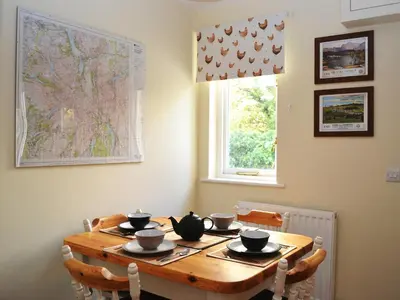 a dining room table with bowls and cups on it at Riverbank in Keswick