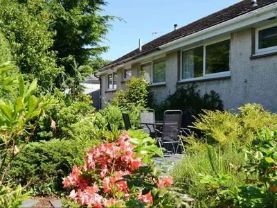 a garden in front of a house with flowers at Haystacks in Keswick