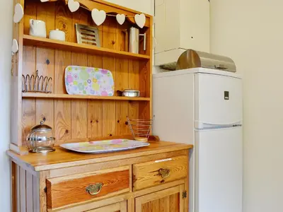 a kitchen with a wooden counter and a refrigerator at Haystacks in Keswick