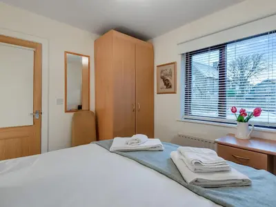 a bedroom with a bed with two towels on it at Chaucer Lodge Apt 1 in Keswick