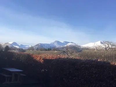 a view of a mountain range with snow covered mountains at The Bolthole Formerly Candlemas in Keswick