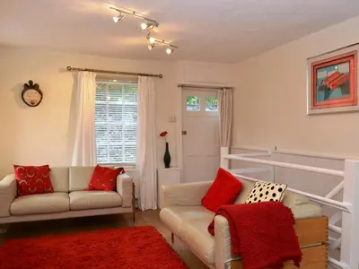 a living room with two couches and a red rug at 4 The Plosh in Keswick