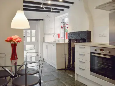 a kitchen with a table and chairs and a dining room at 4 The Plosh in Keswick