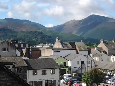 a small town with mountains in the background at Catbells Cottage Keswick in Keswick
