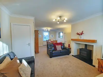 a living room with a couch and a fireplace at Causey Cottage in Keswick