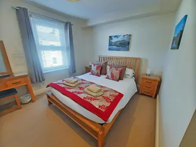 a bedroom with a large bed with two towels on it at Causey Cottage in Keswick