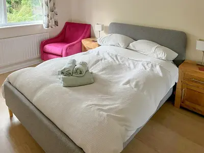 a bedroom with a bed with two towels on it at La'al Gem in Keswick