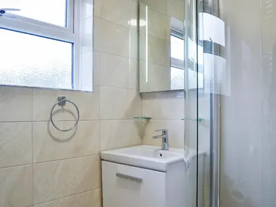 a bathroom with a toilet and a sink and a shower at La'al Gem in Keswick