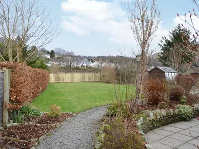 a garden with a yard with a fence and grass at La'al Gem in Keswick