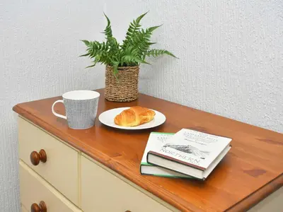 a table with a plate of bread and a plant on it at Osprey Cottage in Bassenthwaite