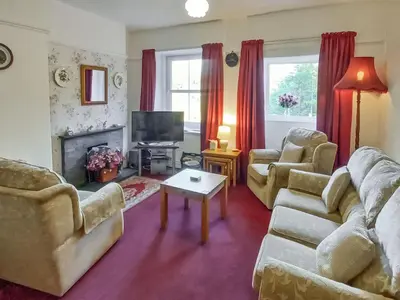 a living room with two couches and a tv at Oak Lea in Braithwaite