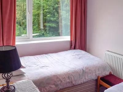 a small bedroom with a bed and a window at Oak Lea in Braithwaite