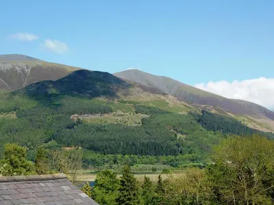 a view of a mountain with trees and a house at Bishop View in Braithwaite