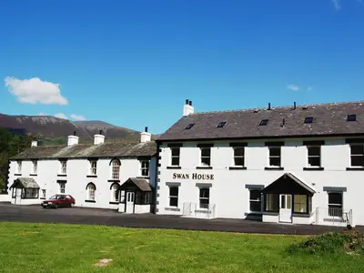 a large white building with a red car parked in front at Bishop View in Braithwaite