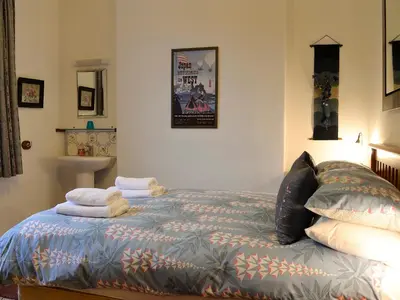 a bedroom with a bed with towels on it at The Larches in Braithwaite