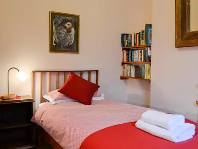 a bedroom with a bed with two towels on it at The Larches in Braithwaite