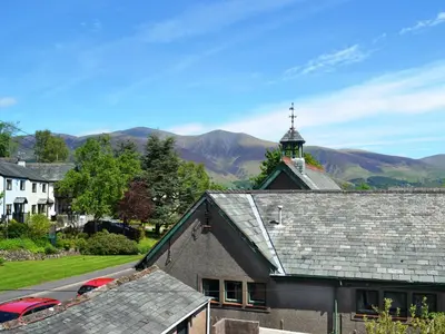 a church with a cross on top of a roof at Croft Cottage in Braithwaite
