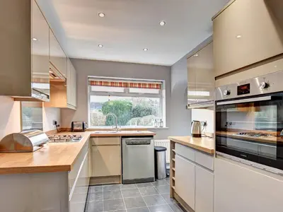 a large kitchen with a sink and a window at Roseworth in Portinscale