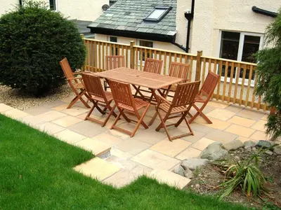 a wooden table and chairs on a patio at Bracken Howe in Portinscale