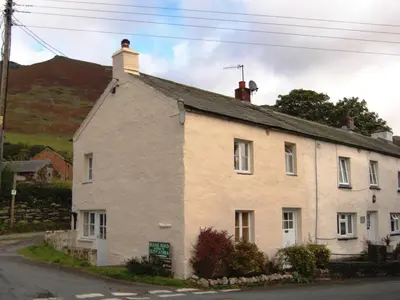 an old white house on the side of a street at Foxhole in Threlkeld
