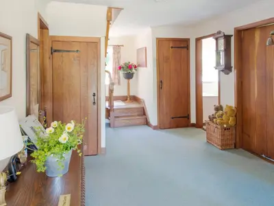 a hallway with wooden doors and aoyer with a table at Lookin How in Dockray