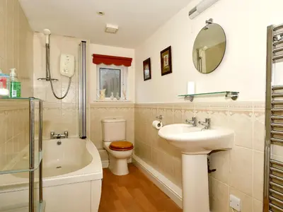 a bathroom with a sink and a toilet and a bath tub at Molly's Cottage in Glenridding