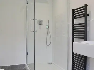 a shower with a glass door in a bathroom at Roundhill Cottages 1 in Grasmere