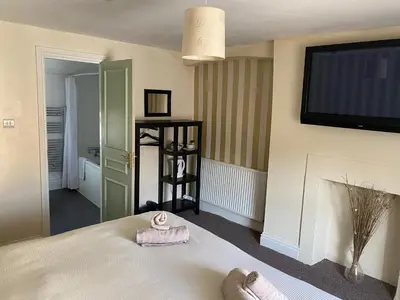 a bedroom with a bed with a towel on it at The Queens in St Bees