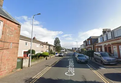 a street with cars parked on the side of the road at Garden Gate Upper Apartment in Prestwick