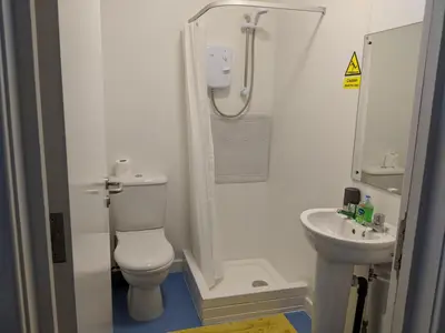 a small bathroom with a toilet and a sink at Barholm Accommodation in Creetown