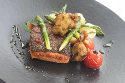 a plate of food with meat and vegetables on it at Hazel Bank Country House Borrowdale Valley in Rosthwaite