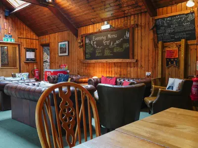 a restaurant with a bar and a chalkboard on the wall at YHA Borrowdale in Rosthwaite