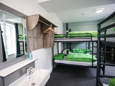 a bathroom with a sink and bunk beds in a room at YHA Keswick in Keswick