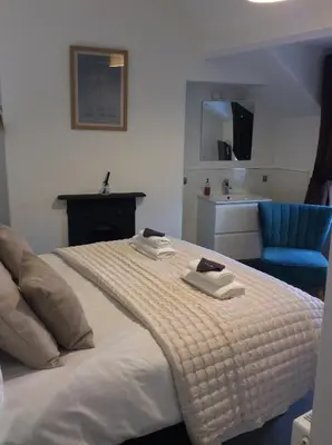 a bedroom with a bed with two towels on it at Dolly Waggon Guest House in Keswick