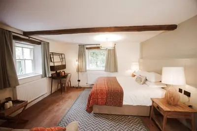 a bedroom with a large bed and a window at Royal Oak Hotel in Rosthwaite