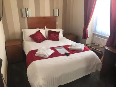 a hotel room with a bed with towels on it at The Globe Inn in Gosforth