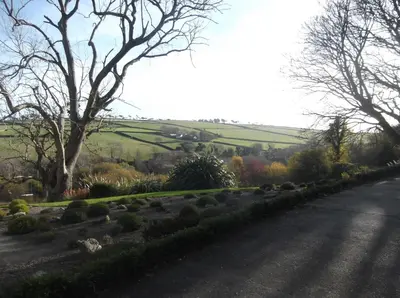 a road with a field in the distance with a helicopter at At Cedar Lodge in Ramsey