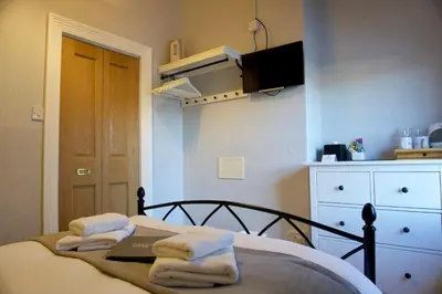 a bedroom with a bed with towels on it at Greystoke House in Keswick