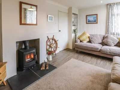 a living room with a couch and a fireplace at Kouloura in Mainsriddle