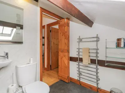 a bathroom with a toilet and a sink at Bleng Barn Cottage in Seascale