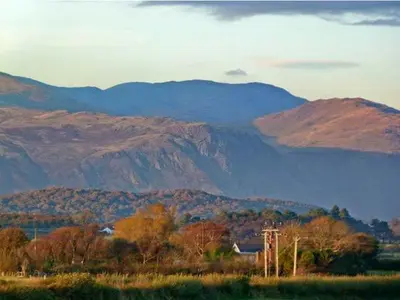 a view of a mountain range with trees and mountains at Gable View in Drigg