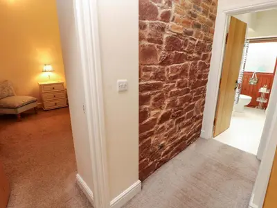 a hallway with a stone wall in a room at The Old Bothy in Wigton