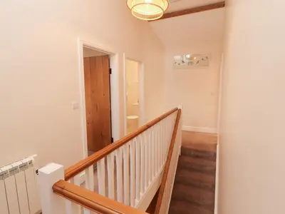 a staircase in a home with a stair case at The Old Grainstore in Wigton