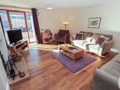 a living room with a couch and a coffee table at The Old Grainstore in Wigton