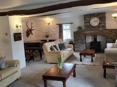 a living room with a couch and a fireplace at High Kiln Bank Cottage in Ulpha