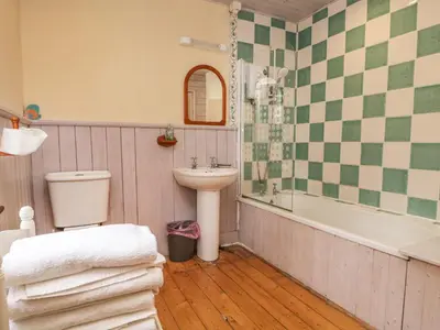 a bathroom with a sink and a toilet and a tub at Peel Place Noddle in Eskdale