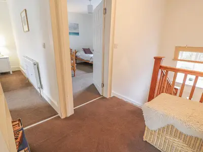 a hallway with a stairway leading to a room at 79 Laurel Bank in Gatehouse of Fleet