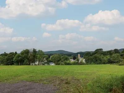 a field with a town in the distance at 79 Laurel Bank in Gatehouse of Fleet