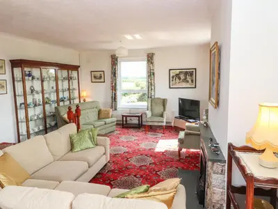 a living room with a couch and a tv at West Croft in Mawbray