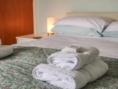 a pile of towels sitting on top of a bed at West Croft in Mawbray